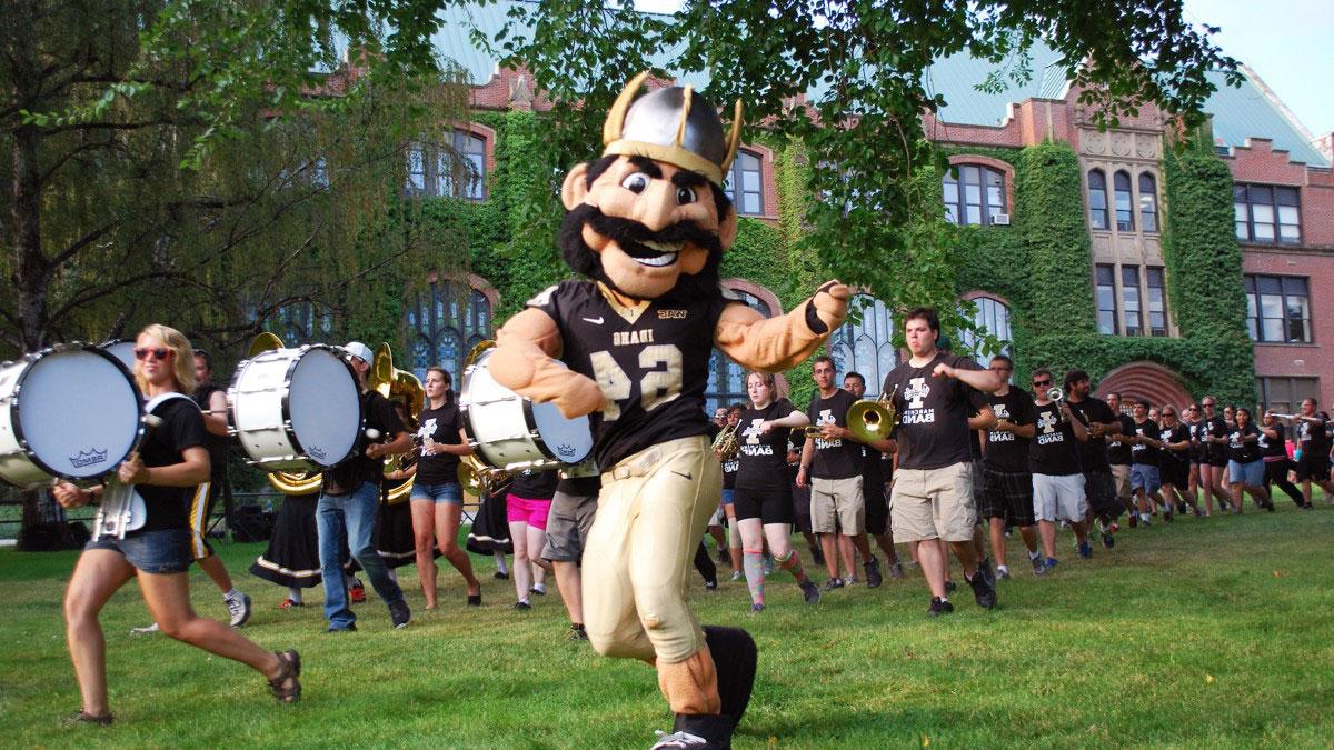 Joe Vandal marches through the Administration Building Lawn with the Vandal Marching band