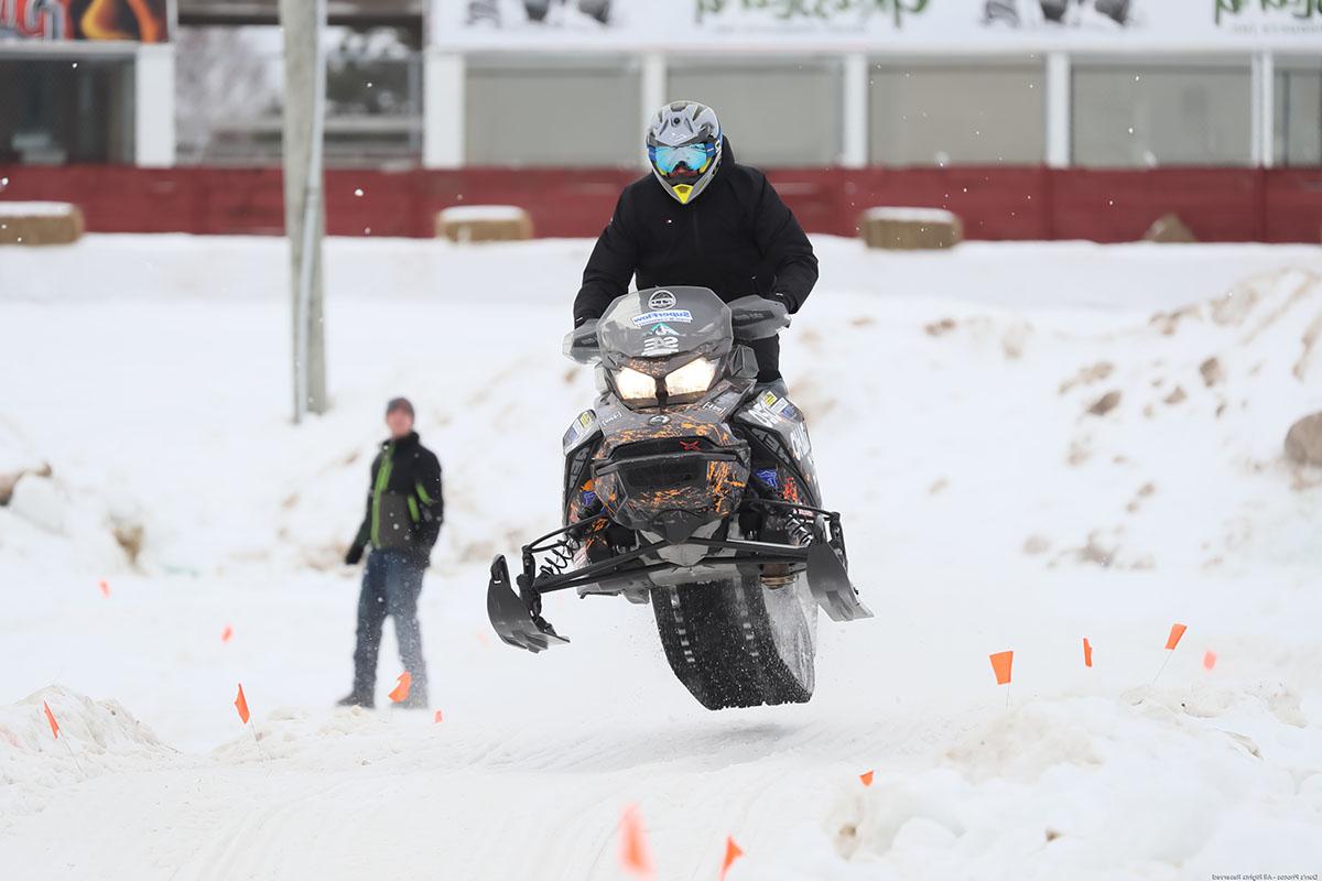 Person riding snowmobile in the air